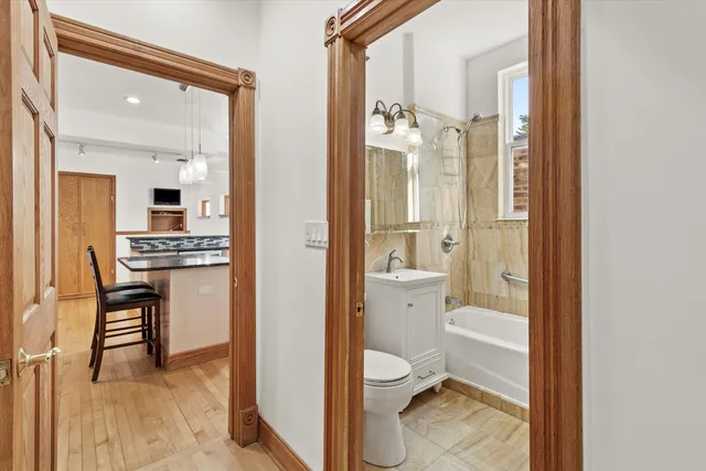 a bathroom with a granite countertop sink mirror and a toilet