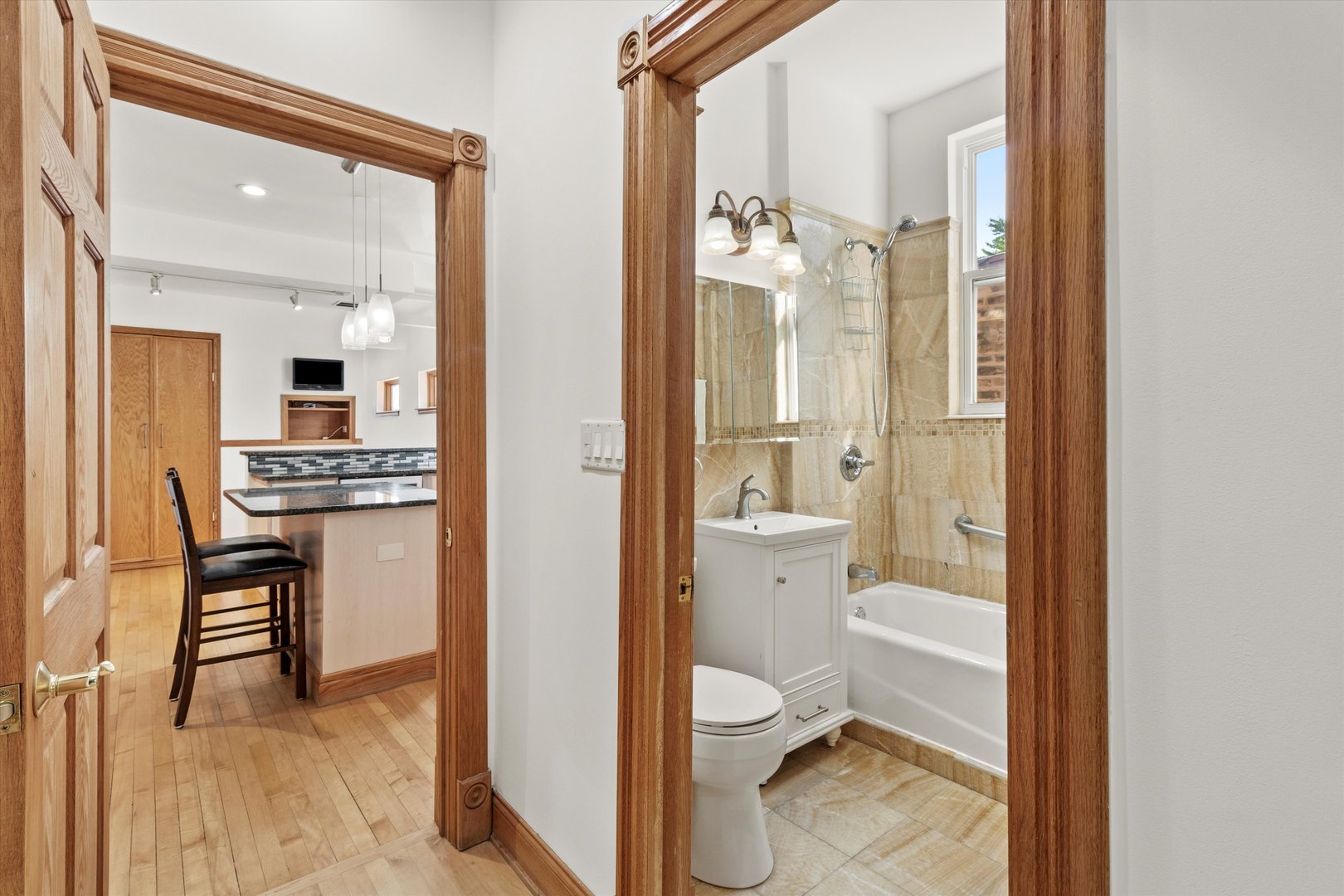 911 North Fairfield Avenue, Unit 2 Chicago, IL 60622 - Photo 13 of 43 a bathroom with a granite countertop sink mirror and a toilet