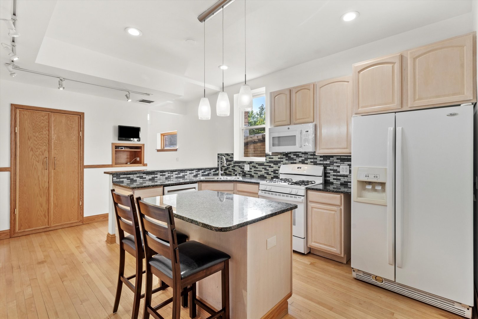 911 North Fairfield Avenue, Unit 2 Chicago, IL 60622 - Photo 15 of 43 a kitchen with refrigerator a sink and chairs