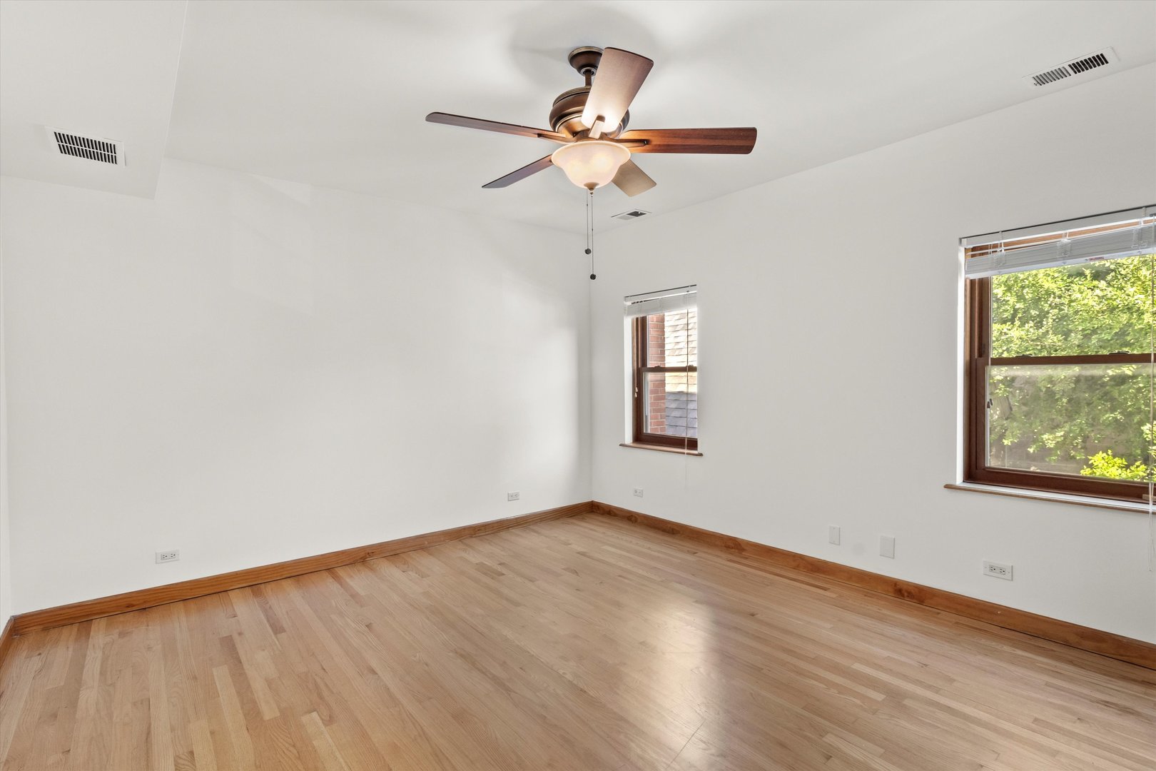 911 North Fairfield Avenue, Unit 2 Chicago, IL 60622 - Photo 21 of 43 a view of an empty room with wooden floor and a window