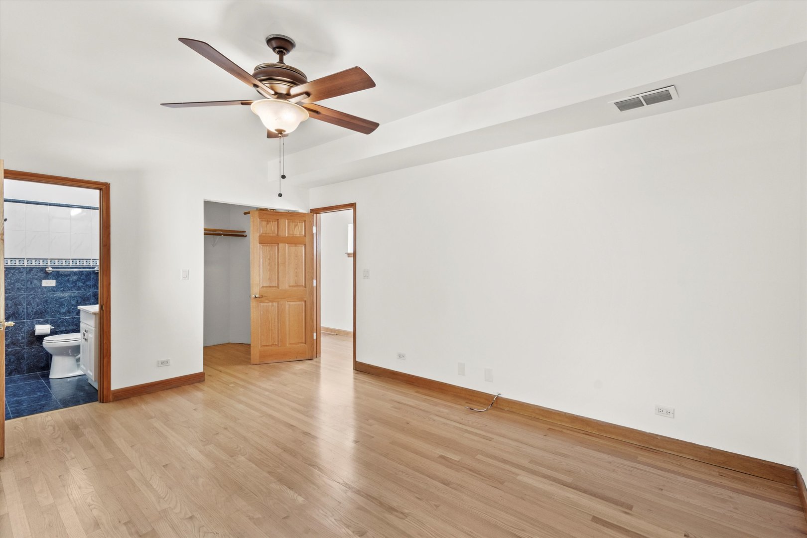 911 North Fairfield Avenue, Unit 2 Chicago, IL 60622 - Photo 23 of 43 an empty room with wooden floor closet and windows