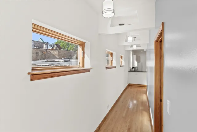 a view of a room with wooden floor