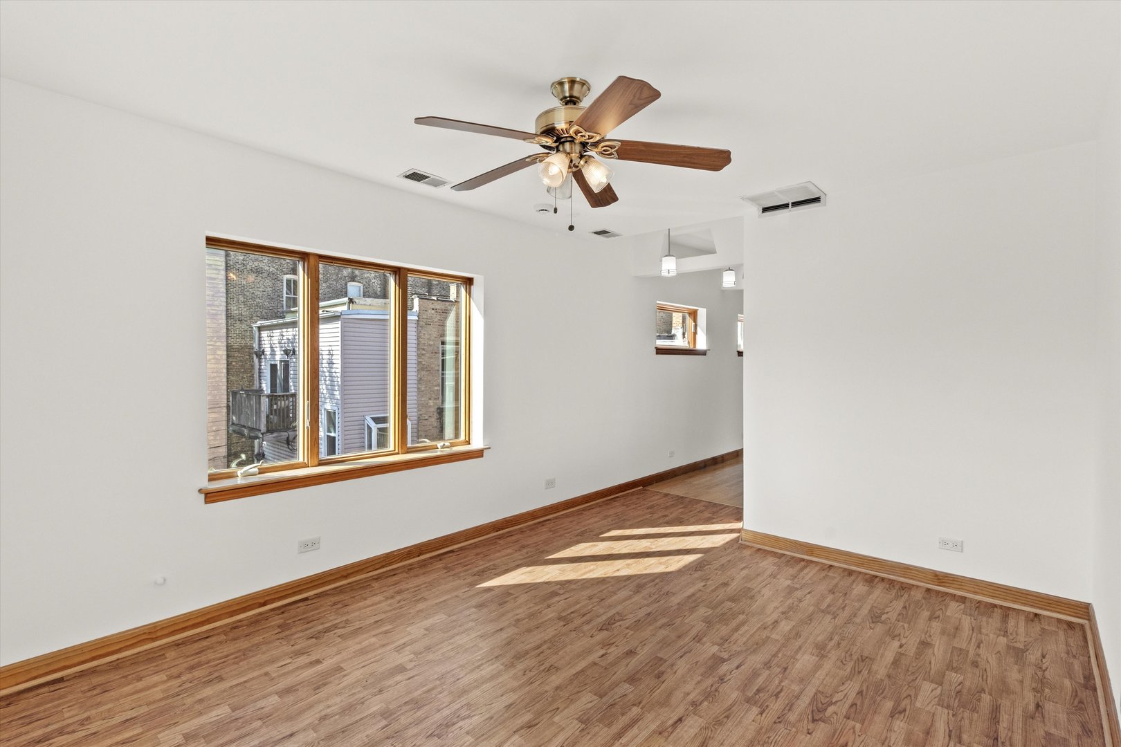 911 North Fairfield Avenue, Unit 2 Chicago, IL 60622 - Photo 30 of 43 an empty room with wooden floor fan and windows