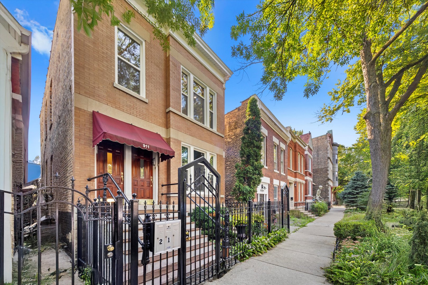 911 North Fairfield Avenue, Unit 2 Chicago, IL 60622 - Photo 3 of 43 a front view of a multi story residential apartment building with a yard