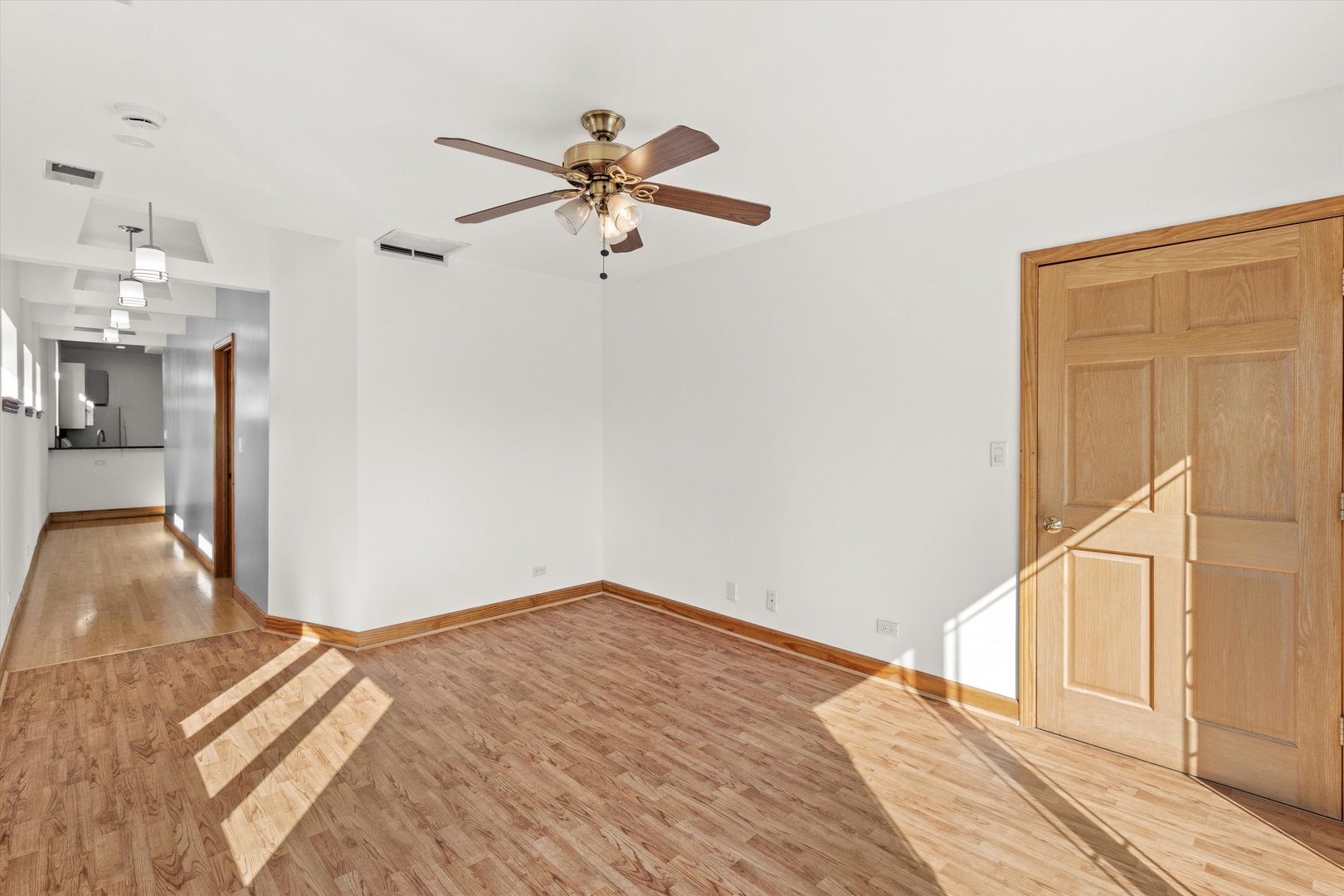 911 North Fairfield Avenue, Unit 2 Chicago, IL 60622 - Photo 31 of 43 a view of a livingroom with wooden floor and a ceiling fan
