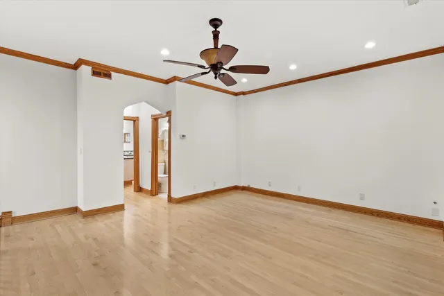 a view of a livingroom with a ceiling fan and wooden floor