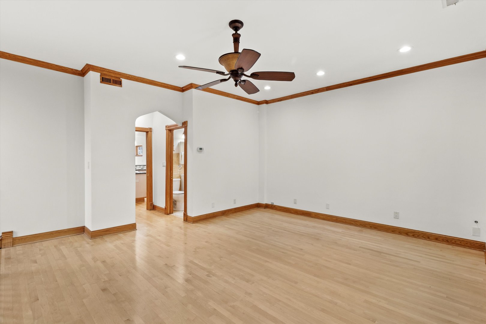 911 North Fairfield Avenue, Unit 2 Chicago, IL 60622 - Photo 9 of 43 a view of a livingroom with a ceiling fan and wooden floor
