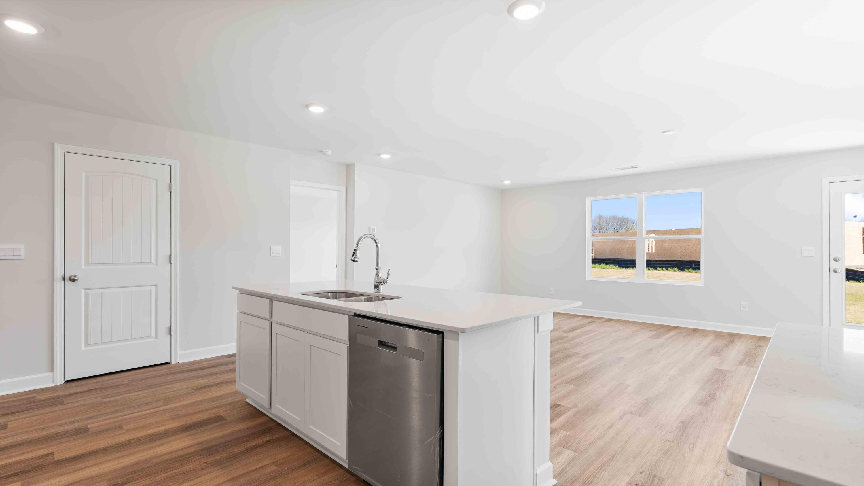5852 Dove Nest Road Gulf Breeze, FL 32563 - Photo 4 of 10 a kitchen with a sink cabinets and wooden floor
