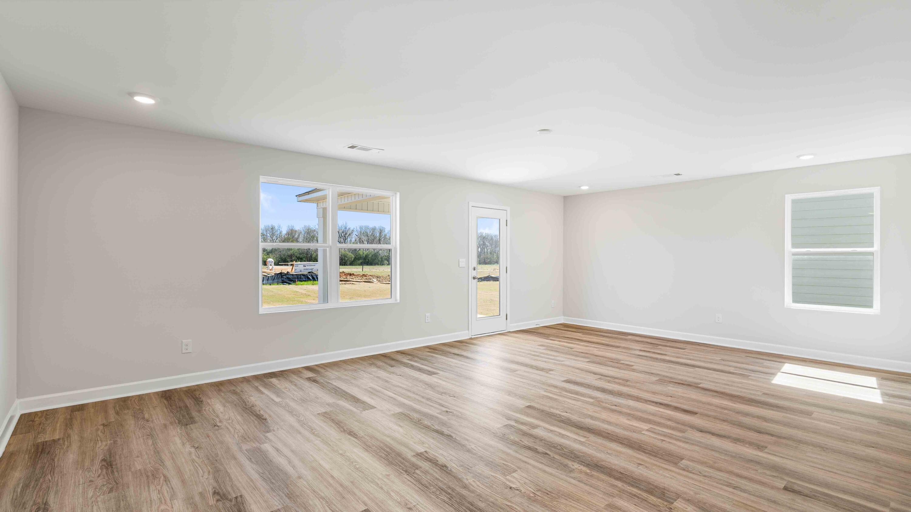 5852 Dove Nest Road Gulf Breeze, FL 32563 - Photo 5 of 10 a view of an empty room with wooden floor and a window