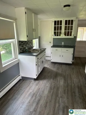 a kitchen with wooden floors and sink