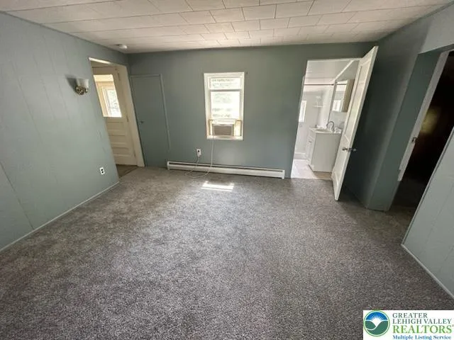 an empty room with windows and closet