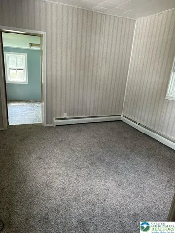 a view of an empty room with a window