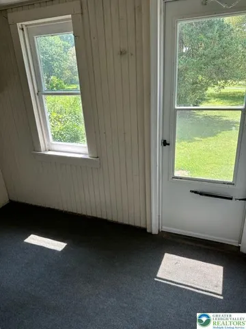 a view of an empty room with a window