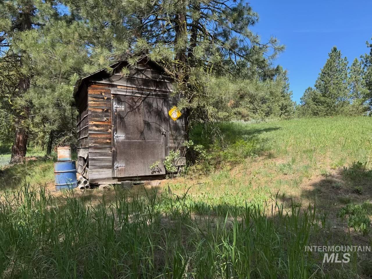 643 South Main Street Cascade, ID 83611 - Photo 5 of 38 View of shed featuring view of wooded area