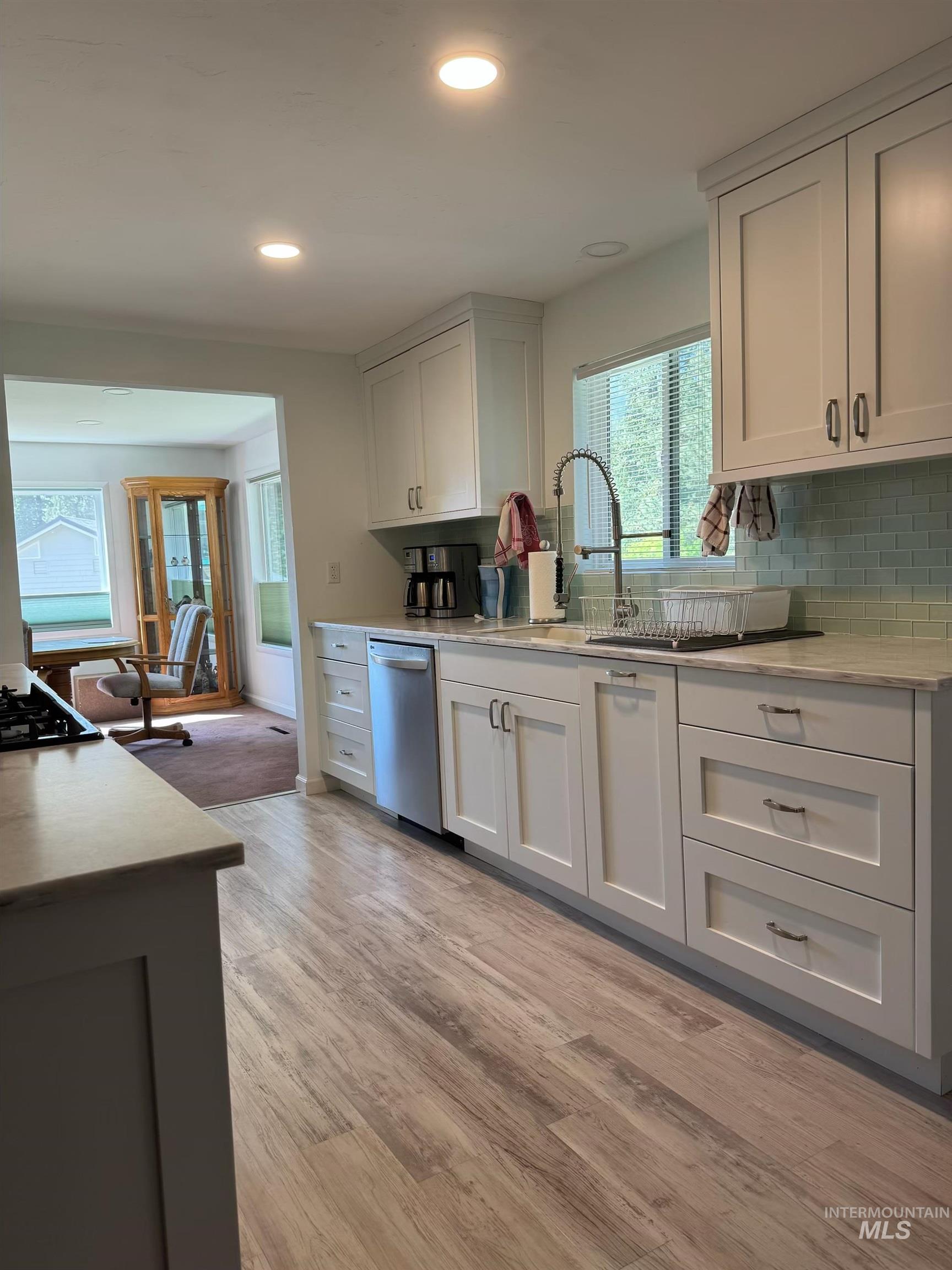 643 South Main Street Cascade, ID 83611 - Photo 8 of 38 Kitchen featuring white cabinets, light stone countertops, light wood-type flooring, and recessed lighting