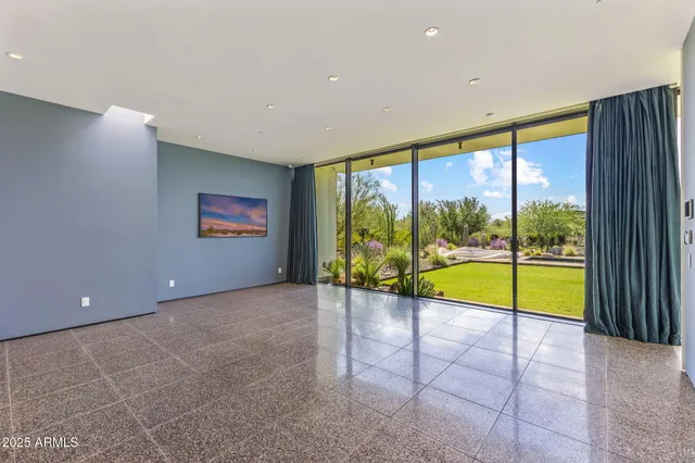 a bathroom with a tub a mirror and a shower