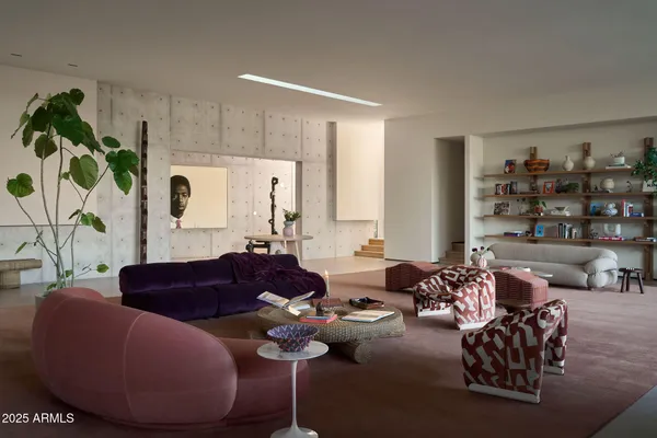 a living room with furniture and potted plant