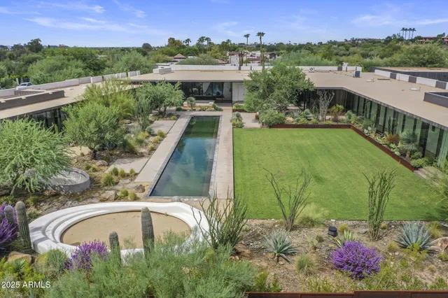 a view of a swimming pool with a yard