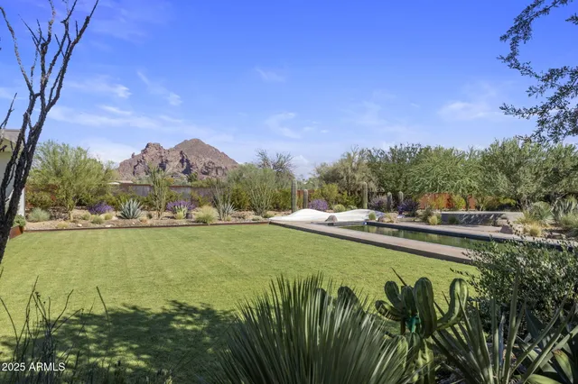 an aerial view of a house with garden space and street view