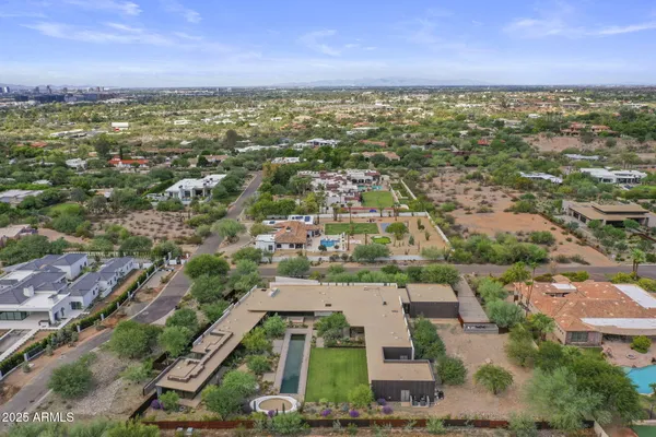 a view of a swimming pool with a yard and plants
