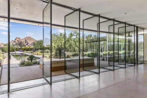 a room with a floor to ceiling windows and city view