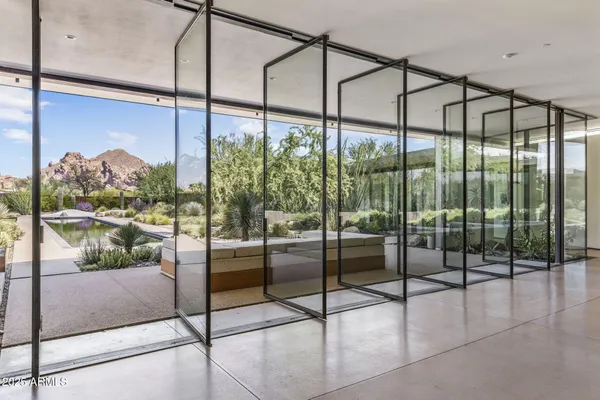 a room with a floor to ceiling windows and city view