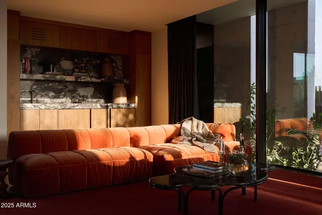 a living room filled with furniture and a large window