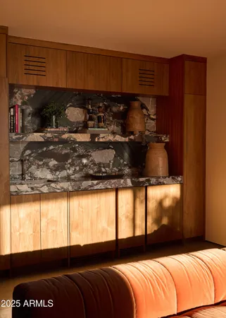 a living room with stainless steel appliances with kitchen island sink refrigerator and window
