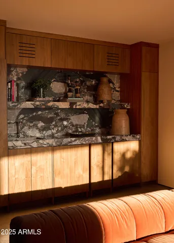 a living room with stainless steel appliances with kitchen island sink refrigerator and window