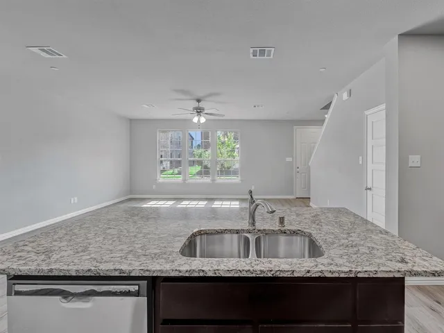 a kitchen with granite countertop kitchen island a stove and a refrigerator