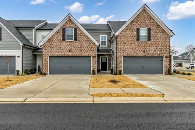 a front view of a house with a yard garage and garage