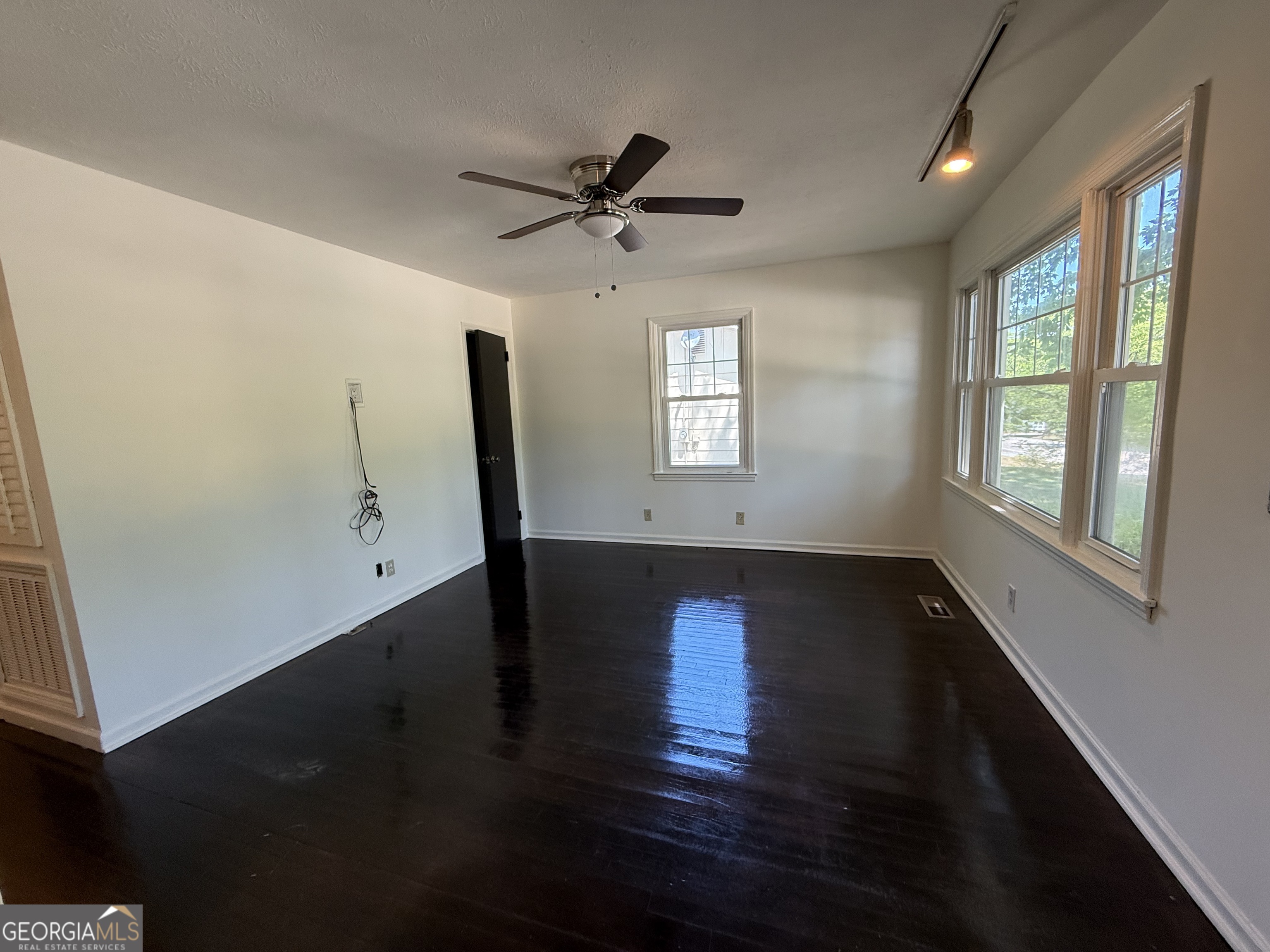 179 Youngs Mill Road LaGrange, GA 30241 - Photo 6 of 30 an empty room with wooden floor fan and windows