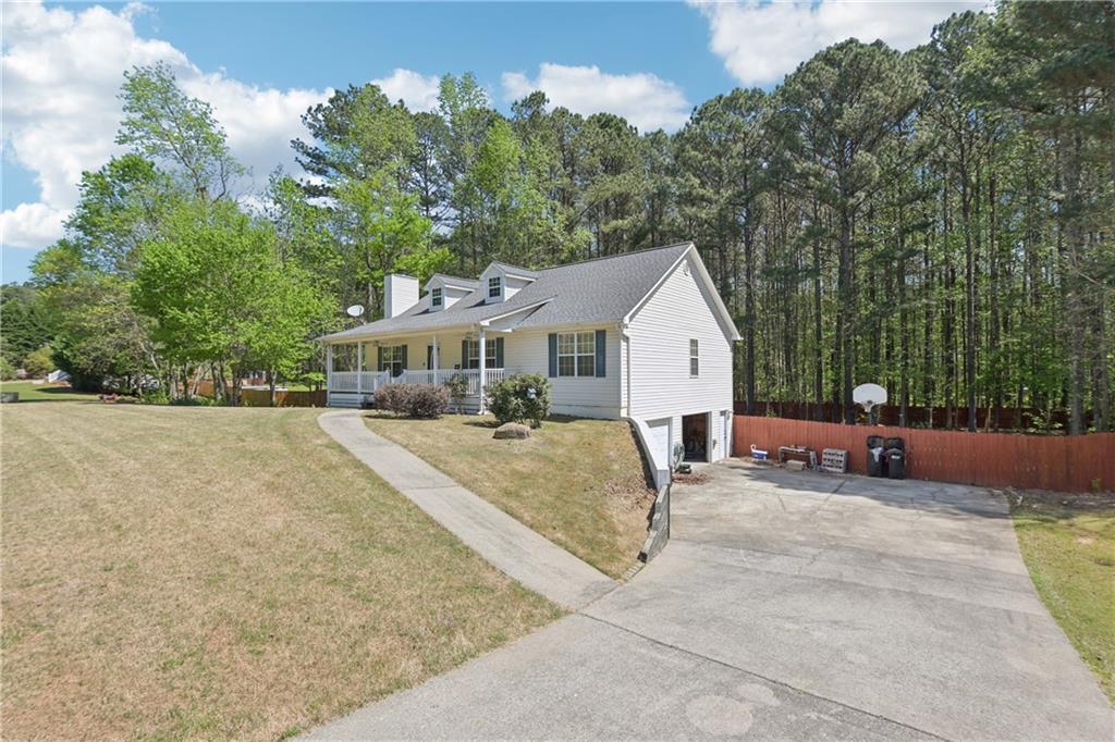 29 Wey Bridge Court White, GA 30184 - Photo 3 of 15 a view of a white house with a big yard and large trees