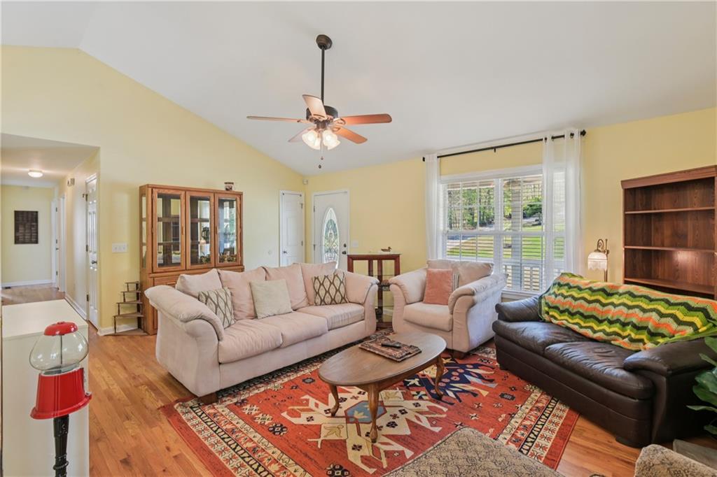 29 Wey Bridge Court White, GA 30184 - Photo 7 of 15 a living room with furniture a chandelier and a window