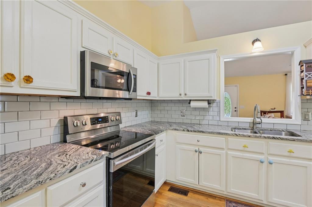 29 Wey Bridge Court White, GA 30184 - Photo 10 of 15 a kitchen with stainless steel appliances granite countertop a sink and a stove