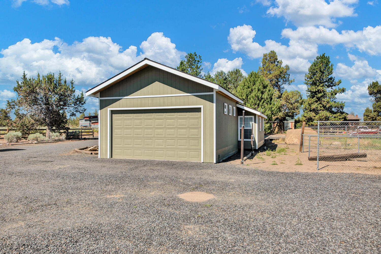 67100 Fryrear Road Bend, OR 97703 - Photo 27 of 38 a view of a house with a yard and garage