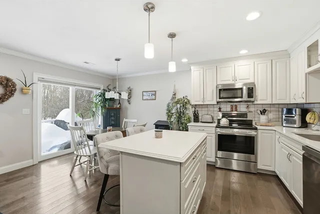 a kitchen with a sink a microwave a stove and refrigerator