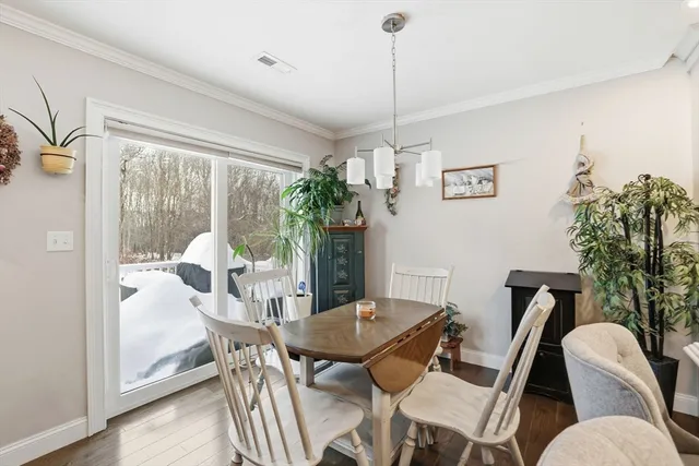 a view of a dining room with furniture wooden floor and a chandelier