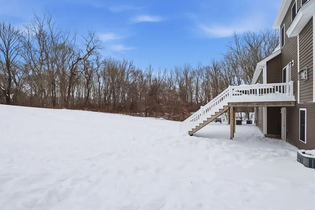a view of roof deck with a house and trees with wooden fence