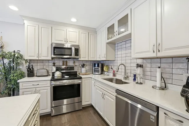 a kitchen with a sink stove and microwave