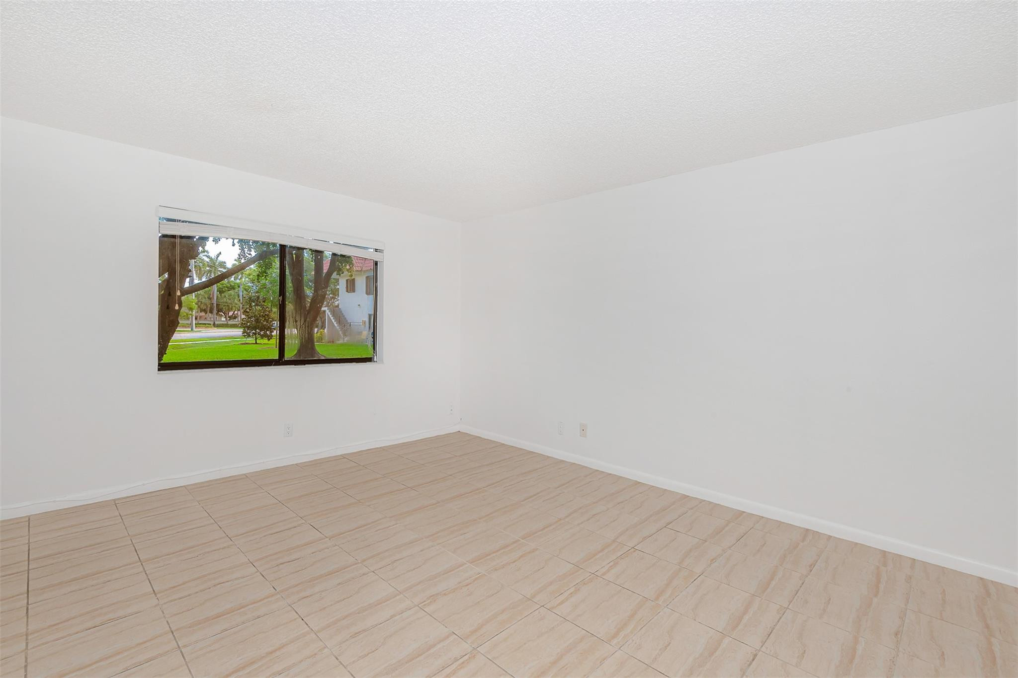 340 Racquet Club Road, Unit 101 Weston, FL 33326 - Photo 16 of 29 a view of empty room with window