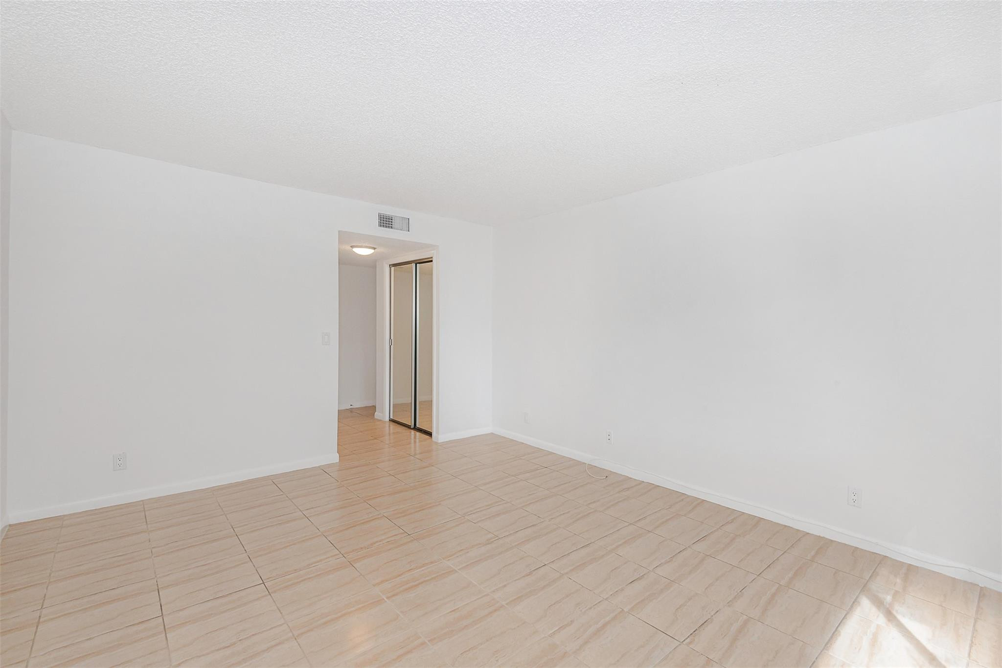 340 Racquet Club Road, Unit 101 Weston, FL 33326 - Photo 18 of 29 a view of an empty room with wooden floor and a window