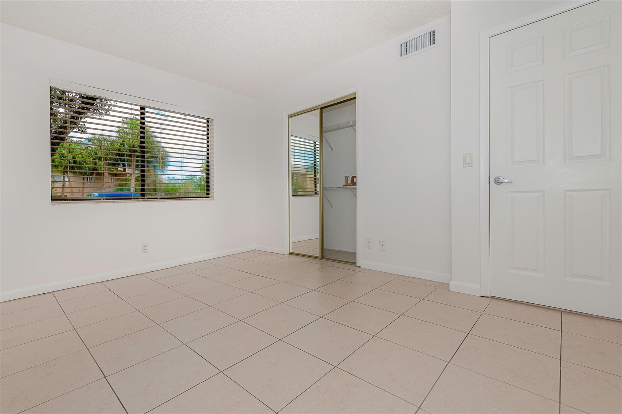 340 Racquet Club Road, Unit 101 Weston, FL 33326 - Photo 23 of 29 a view of an empty room with a window