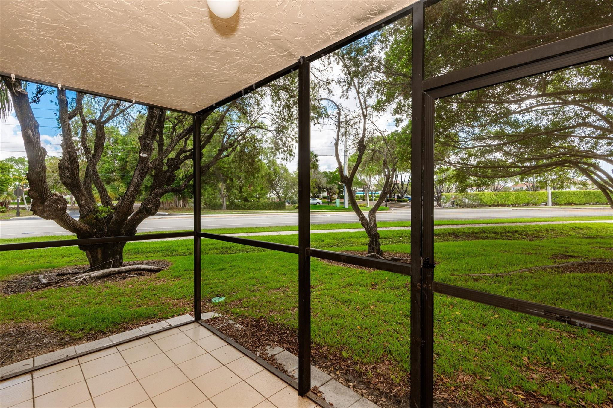 340 Racquet Club Road, Unit 101 Weston, FL 33326 - Photo 27 of 29 a view of a trees from a porch