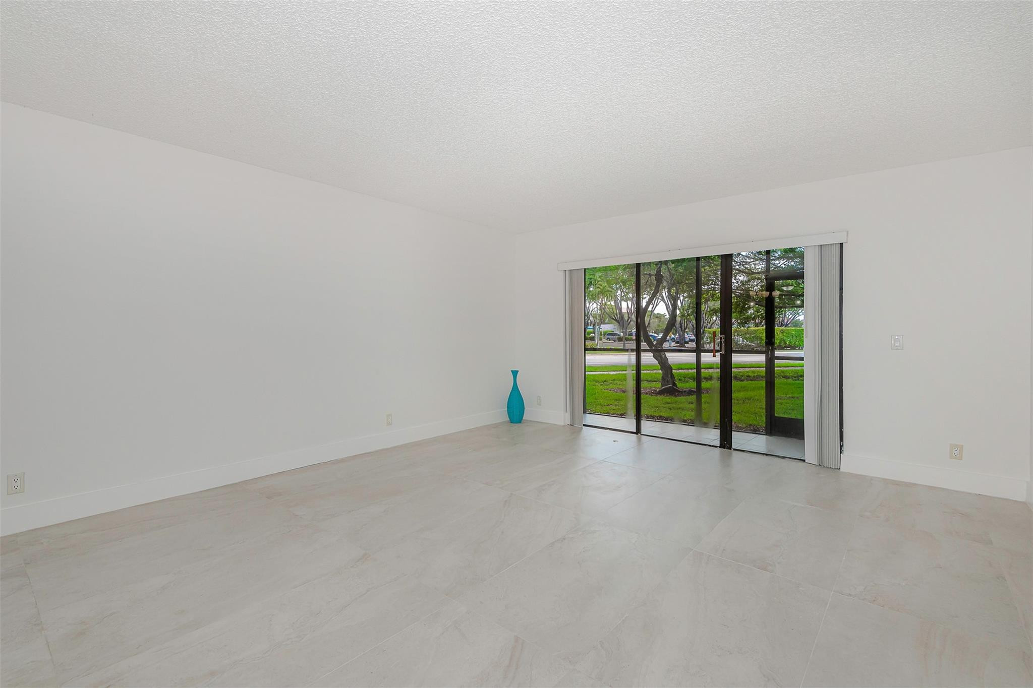 340 Racquet Club Road, Unit 101 Weston, FL 33326 - Photo 5 of 29 a view of an empty room with a sliding door