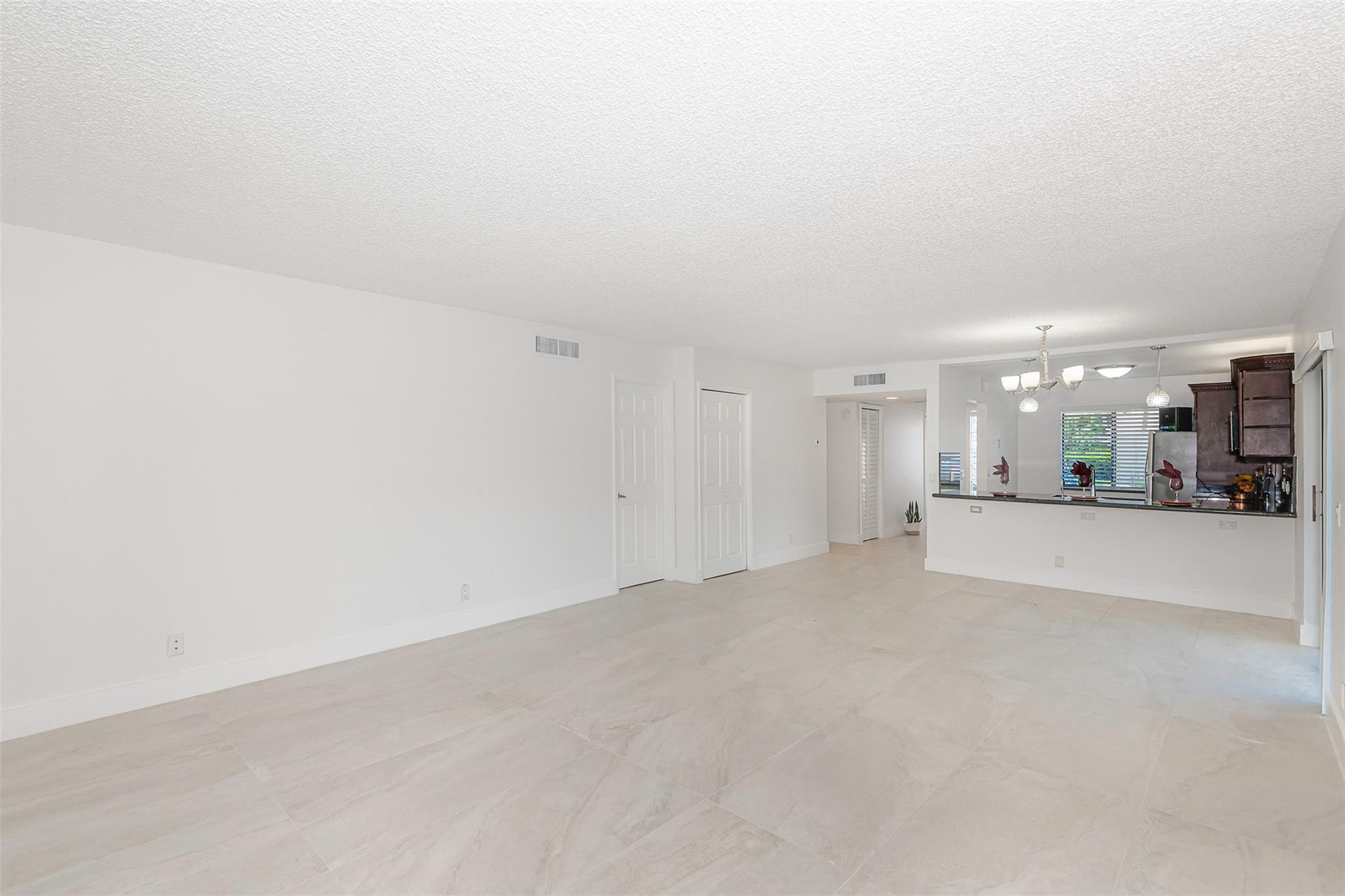 340 Racquet Club Road, Unit 101 Weston, FL 33326 - Photo 7 of 29 a view of a livingroom and a mountain