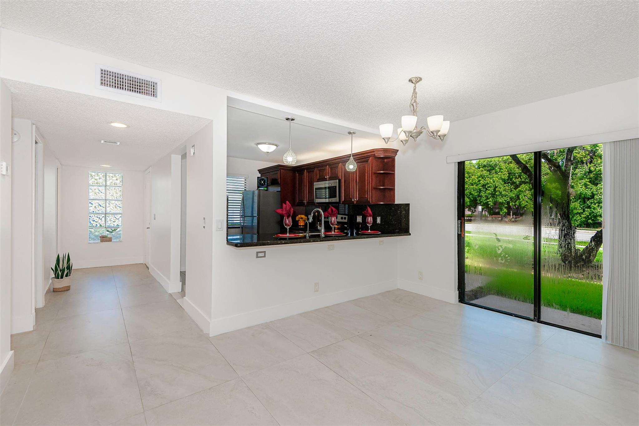 340 Racquet Club Road, Unit 101 Weston, FL 33326 - Photo 9 of 29 an empty room with wooden floor and windows