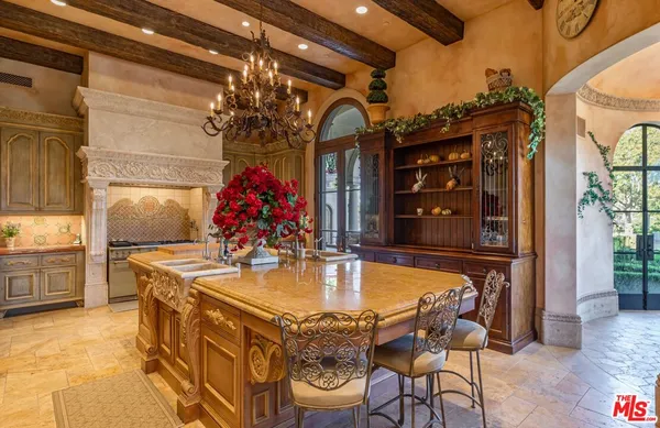 a dining table with chairs and chandelier