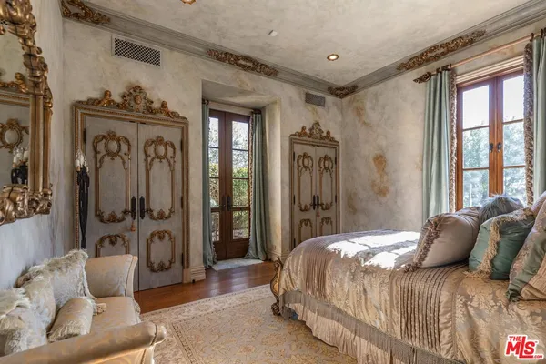 a bedroom with a bed couch and a window