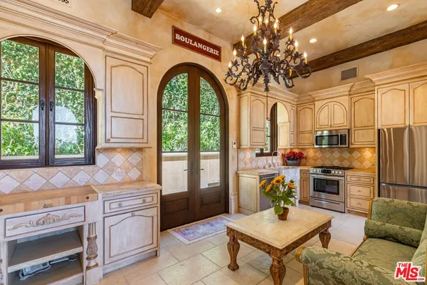 a patio with water view fountain and a tree
